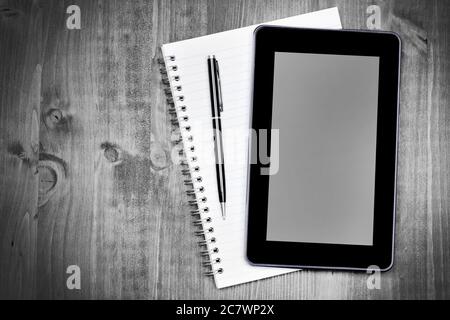 Digital tablet pc and notebook  with pen on desk Stock Photo