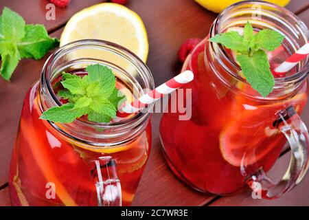 Raspberries lemonade in a jars on wooden table Stock Photo