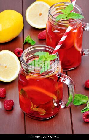 Raspberries lemonade in a jars on table Stock Photo