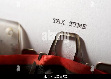 Tax time text written with a typewriter. Stock Photo
