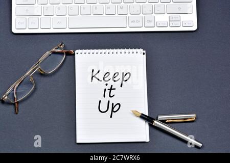 Keep it up text on notebook on a black background Stock Photo