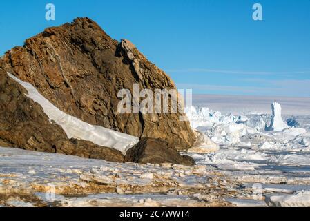 the harsh nature and landscapes of Antarctica. The ocean, icebergs and cold land. Stock Photo