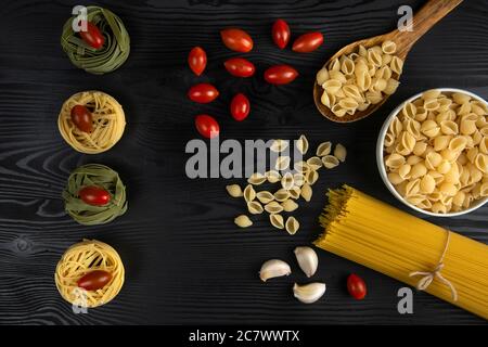 Pasta varieties served with tomatoes and garlic Stock Photo