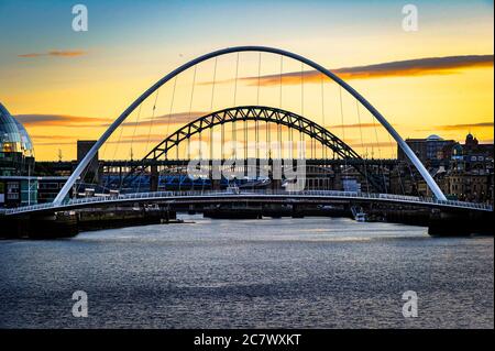 NEWCASTLE, UK. 19 July 2020. The sky turning from blue to yellow over the bridges in Newcastle, Tyne and Wear, England.  Photo © Matthew Lofthouse