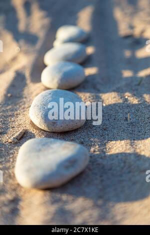 Lined smooth pebbles in the sand, Copy space . High quality photo Stock Photo