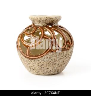Beautiful round ceramic flower vase with decorative openwork cuts around the narrow neck. Isolated on white background. Interior design element. Stock Photo