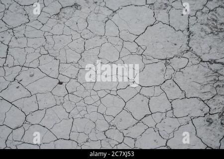 High angle shot of cracked grey ground texture Stock Photo