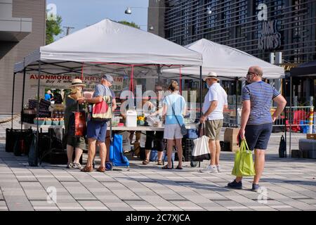 Lansdowne Farmers Market in Ottawa: People lining up, keeping distance from each other buying produce for fruit and vegetable stall Stock Photo