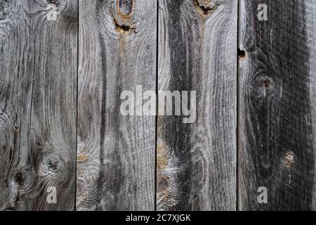 Photograph of  the weathered natural siding of an old New England barn, showing the texture of the wood including the knots Stock Photo