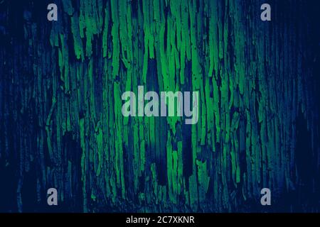 Cracked and peeling paint texture on an old wooden wall with colorful green and blue color effect Stock Photo