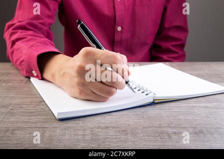 Picture of a man making notes on a notebook Stock Photo