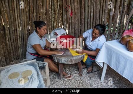 Two Mayan women making fresh tortillas by hand in a restaurant in Valladolid, Yucatan, Mexico. Stock Photo