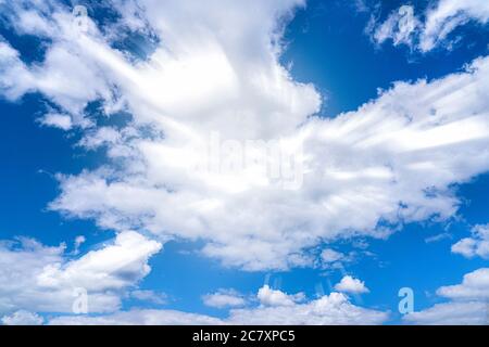 blue bright contrasting cold sky, the sun's rays break through the clouds. Stock Photo