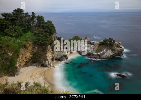 McWay Falls, turquoise waters, and the sandy beach near Big Sur along the coast of California, USA Stock Photo