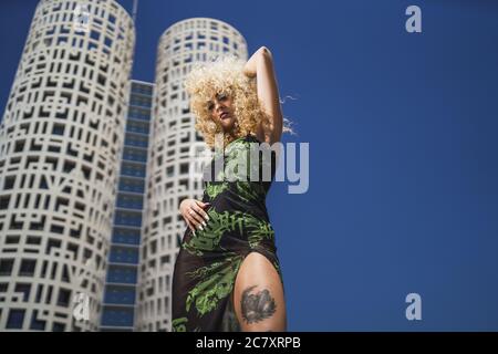 Beautiful and attractive woman with blond curly hair posing Stock Photo