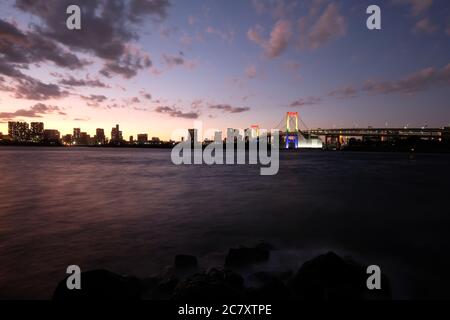 Panoramic view of rainbow bridge in tokyo at sunset. long exposure Stock Photo