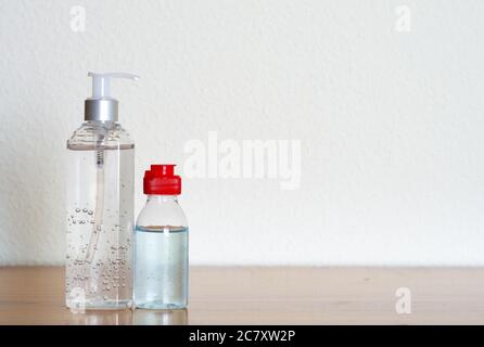 Big and small hand sanitizer gel containers on white background Stock Photo