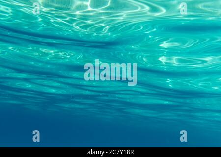 Summer time under the sea ocean water with a ray of sunlight from the surface for a background concept design Stock Photo