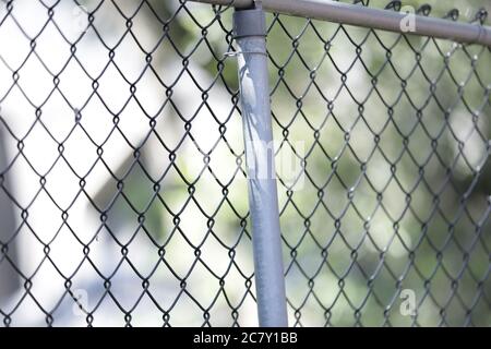 Chain Link fence and metal post in selective focus Stock Photo