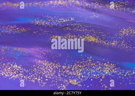 Dark acrylic hand drawn texture in violet colour with golden glitter. Festive backdrop. Stock Photo