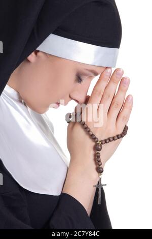 portrait of young beautiful woman nun praying with rosary isolated on white background Stock Photo