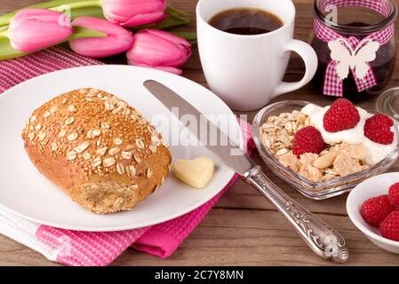 Richly laid breakfast table in springtime Stock Photo