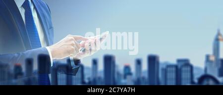 business man using mobile phone at office with double exposure technic with city building background Stock Photo