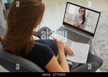 Remote work. Young woman talking to boss or colleague on laptop at home. Businesswoman communicating with client online Stock Photo