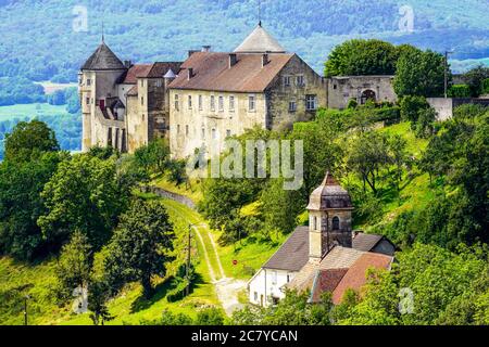 Medieval Chateau (castle) de Belvoir in Doubs department of the Bourgogne-Franche-Comte region in France. Overlooking  Belvoir village  and the valley Stock Photo