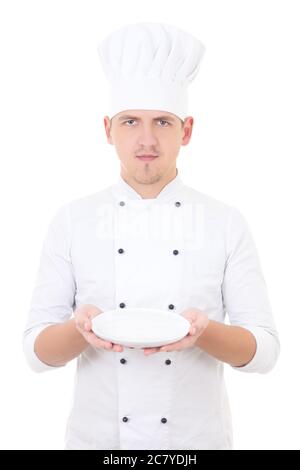 young man chef  in uniform showing empty plate isolated on white background Stock Photo