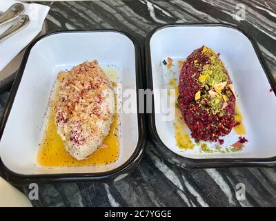 Turkish Greek Appetizer Meze Platter Nuraniye with Yogurt and Kisir with Beet and Made with Beetroot, Orange and Pistachio Powder. Ready to Serve. Stock Photo