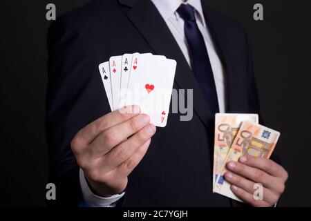 four aces cards and euro banknotes in mans hands Stock Photo