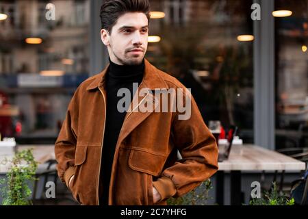 Young handsome stylish man intently looking away waiting on street Stock Photo