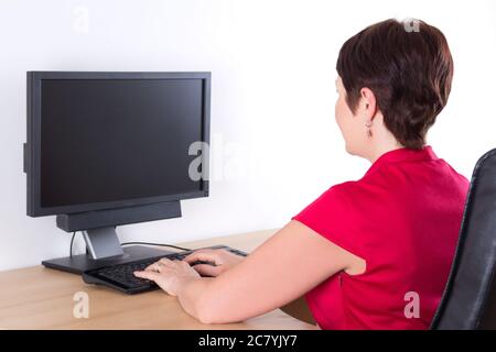 businesswoman using pc with blank display in office Stock Photo