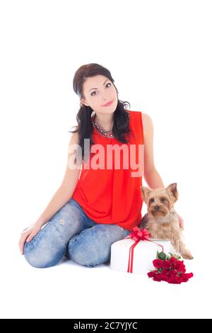 beautiful woman sitting with little dog yorkshire terrier, gift box and flowers isolated on white background Stock Photo