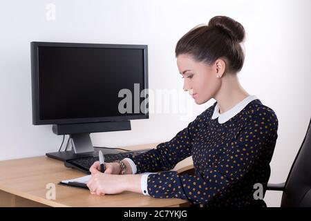 young beautiful successful business woman working in office and computer with blank monitor screen Stock Photo