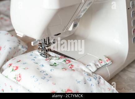 Sewing machine presser foot, needle sews with colorful fabric in. Selective focus Stock Photo