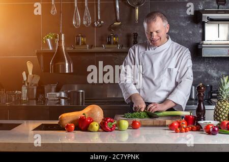 Cook's hands preparing vegetable salad Stock Photo