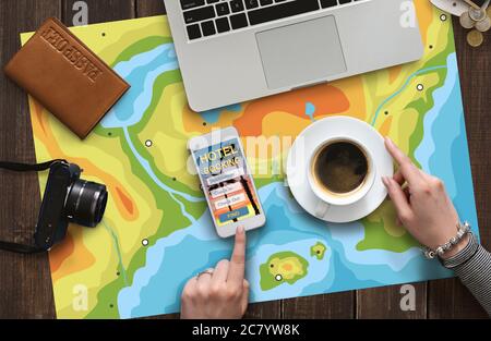 Woman drinking coffee and choosing hotel on smartphone Stock Photo