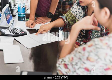 Group of tourist woman discuss details of payment receipt at hotel reception. Stock Photo