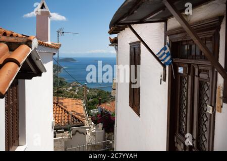 Picturesque alleys in the village of Glossa on the Greek island of Skopelos with white houses and colorful windows and balconies. Stock Photo