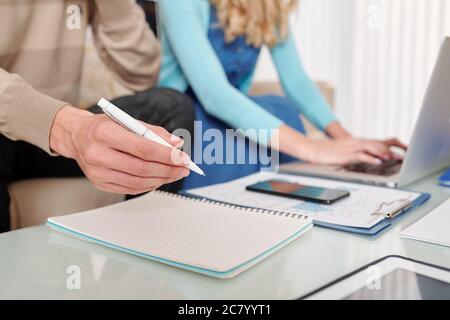 Close-up image of businessman analyzing financial chart and writing down ideas and plans Stock Photo