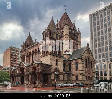 Boston, Massachusetts, USA. Romanesque Trinity Church in historic downtown Boston, surrounded by modern skyscrapers Stock Photo