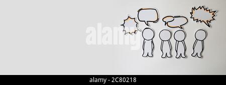 Paper figures with speech bubbles on the white Stock Photo