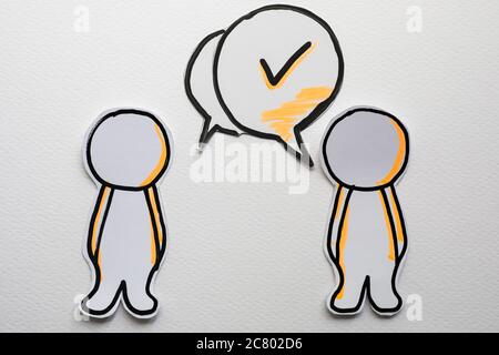Paper figures with speech bubbles on the white Stock Photo