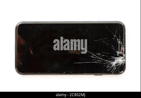 Mobile cell phone with broken display screen after drop. Crashed black smartphone on white background. Flat lay image seen from above. Stock Photo
