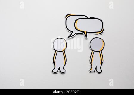 Paper figures with speech bubbles on the white Stock Photo