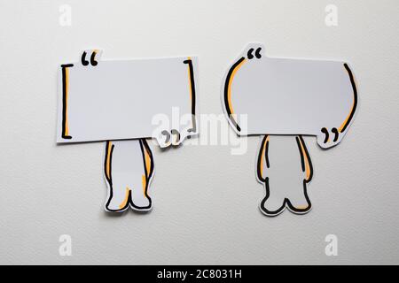 Paper figures with speech bubbles on the white Stock Photo