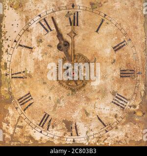 Vintage and heavily weathered clock face with time set to a few minutes to twelve o clock Stock Photo