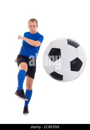 young attractive soccer player in blue uniform kicking leather ball isolated on white background Stock Photo